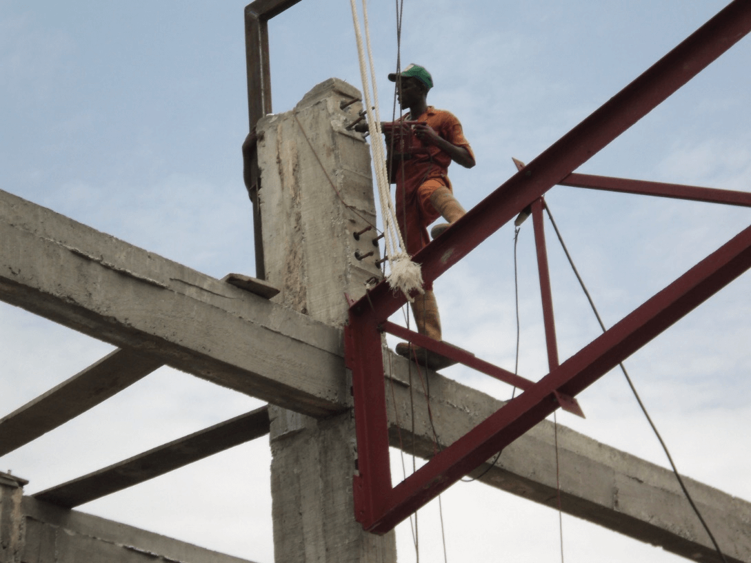 B. Our parallel chord truss being hoisted into position for bolting on to the RC framework..